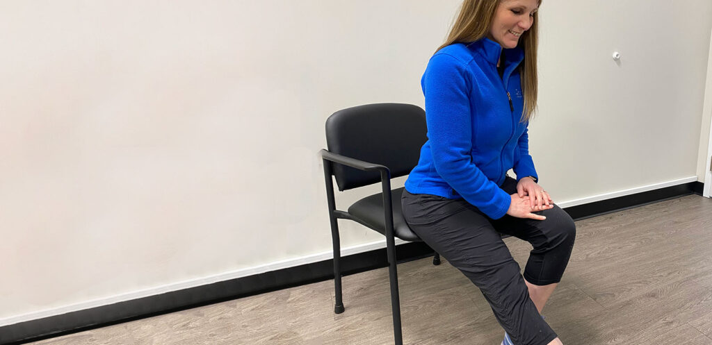 Physiotherapist doing a seated hamstring stretch